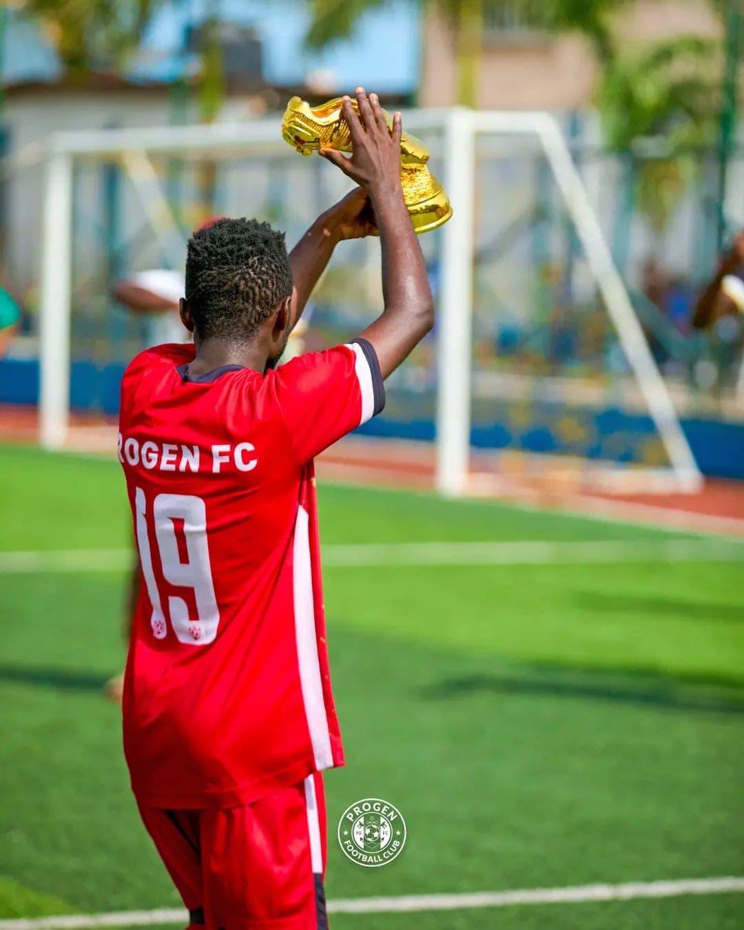 ProGen FC player lifting a trophy